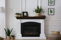Retique It Liquid Wood Wood'n Stain in Classic Black applied to a fireplace mantle, showcasing its rich black finish.